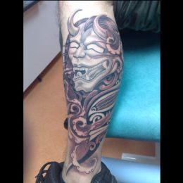 Masque hannya et volutes en noir et gris sur le mollet