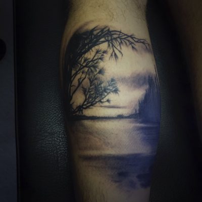 Paysage d'arbre au bord de l'eau en noir et gris sur le bras