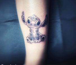 Petit personnage en noir et gris sur l'avant-bras